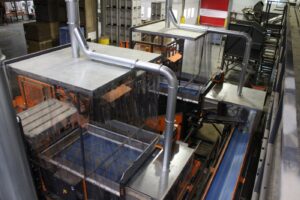 New dust extraction and shielding above the automated crate unloading line.