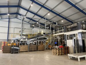 Overview of the potato line in a new shed with conveyor belts, sorting machines and extraction pipes.