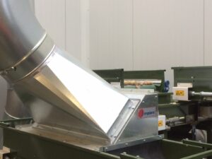 Close-up of a metal Jongejans suction unit next to a potato conveyor belt, part of the windshifting technology.