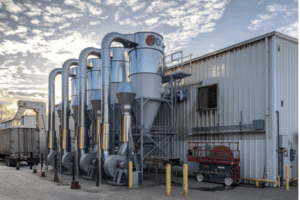 Row cyclone installations outside a processing site, part of the extraction system for agricultural products.