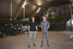 Two employees of De Lugt Potato Farm stand in the sorting area in front of the new potato sorting line with extraction.
