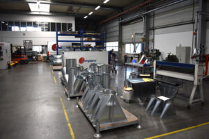 Component production in the Jongejans Luchttechniek workshop, with various metal cyclone and extraction parts being assembled.