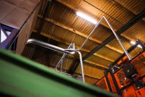 Collection point of extraction pipes above the sorting machine in the shed.