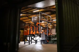 Sorting facility in a barn, seen from the doorway.