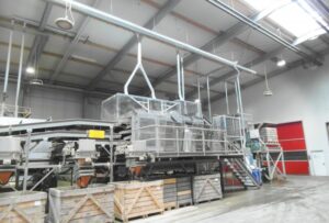 Extraction points and pipework above an agricultural sorting line where dust and skins are extracted.